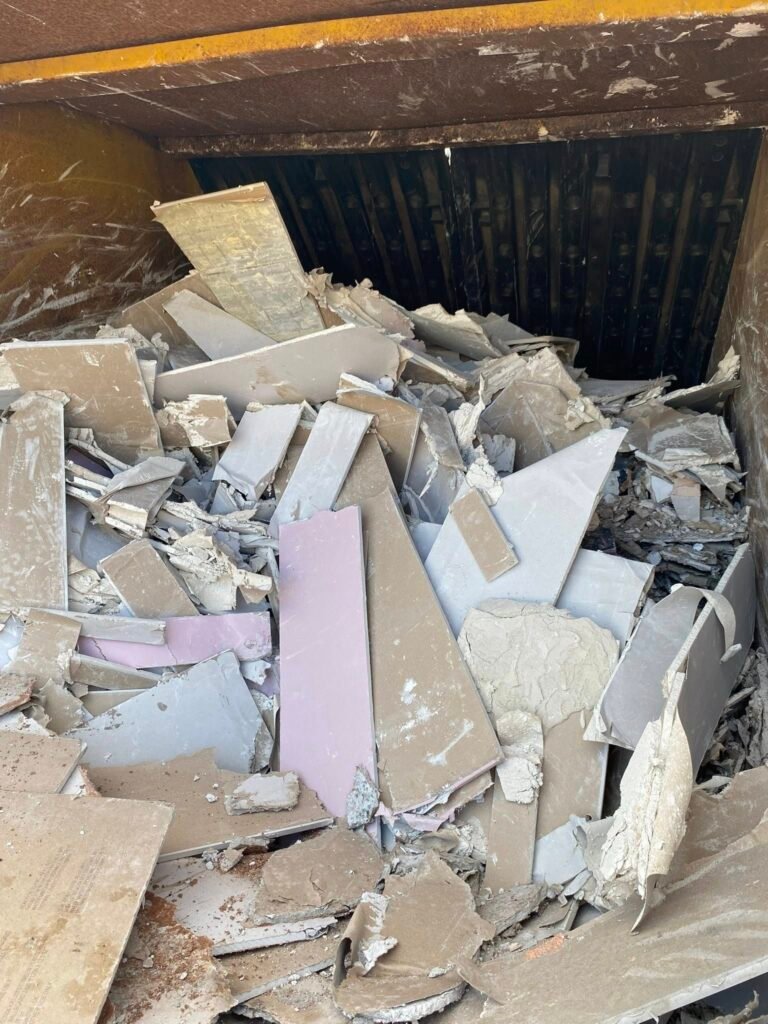 Plasterboard in an enclosed skip ready for recycling